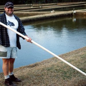 Figure 3b. A long pole with a can attached to the end can be used to reach deep areas of the pond.