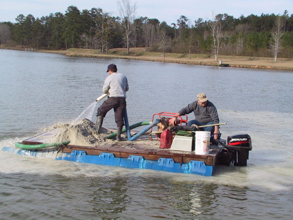 Figure 4. Applying lime from a barge.