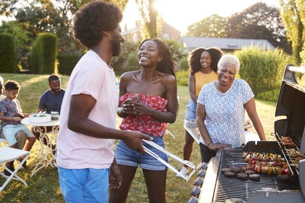 African American couple laughing at a multi generation family barbecue
