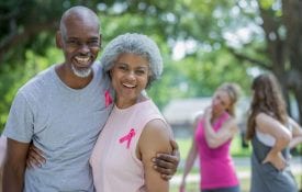 Senior couple attending charity breast cancer race for the cure.