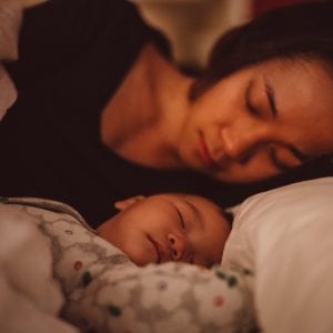 Mom sleeping with baby