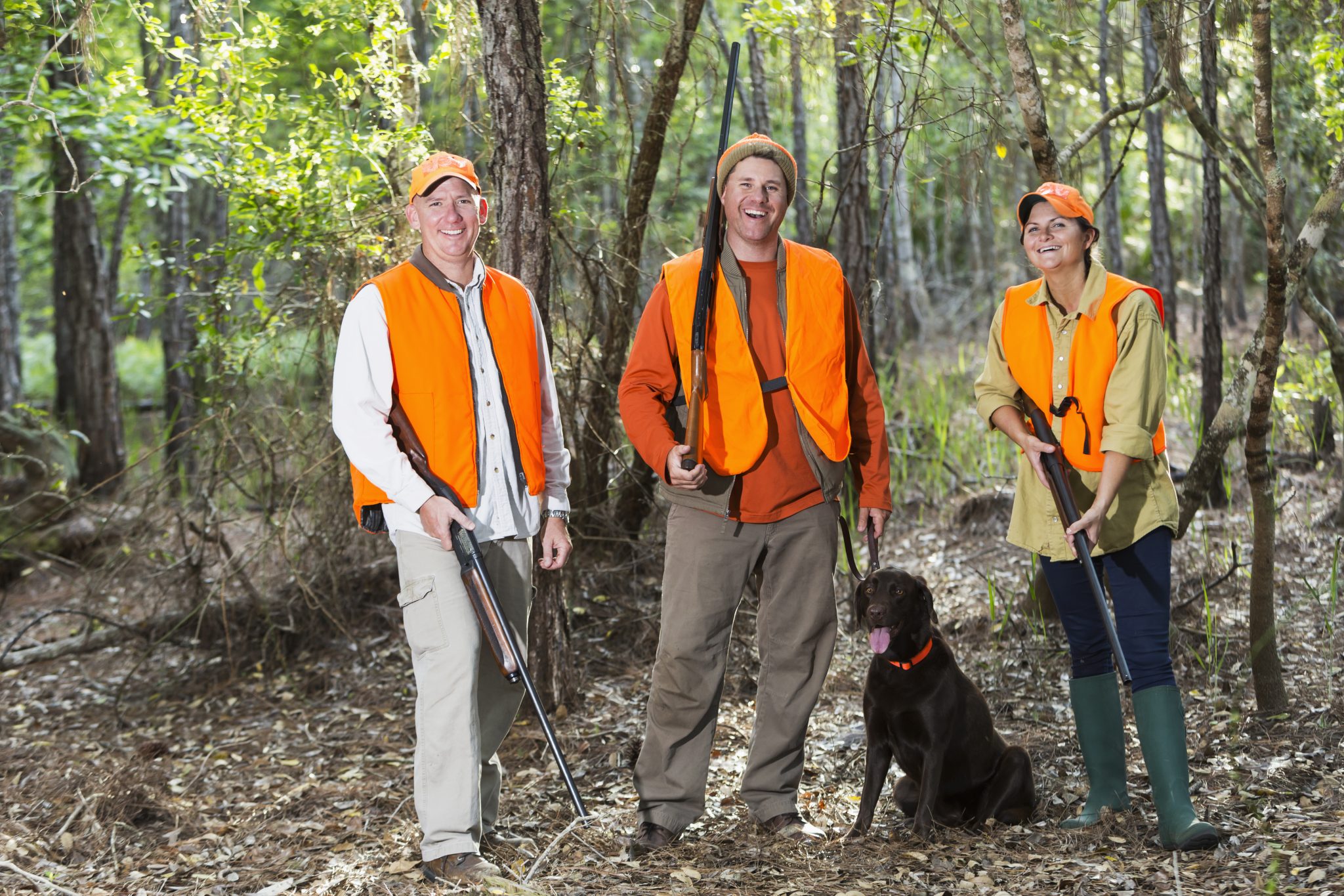 Three hunters with hunting dog