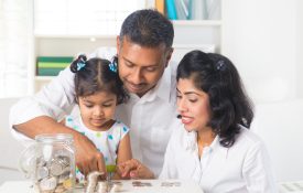 Indian family teaching about saving money