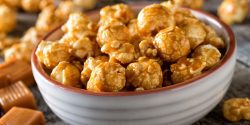 A bowl of delicious homemade caramel coated popcorn.