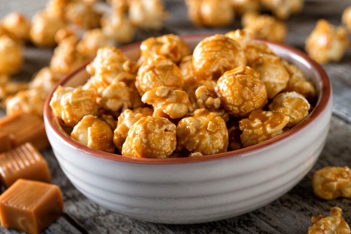 A bowl of delicious homemade caramel coated popcorn.