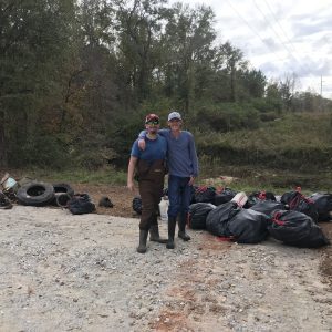 Volunteers remove litter from Pepperell Branch Creek.