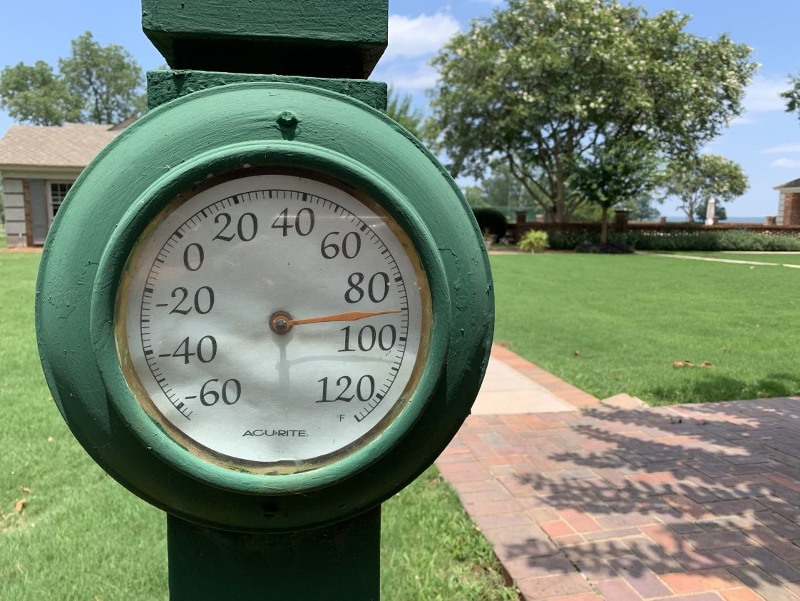 An outdoor thermometer showing 92 degrees