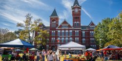 People tailgating outside Samford Hall on the campus of Auburn University.