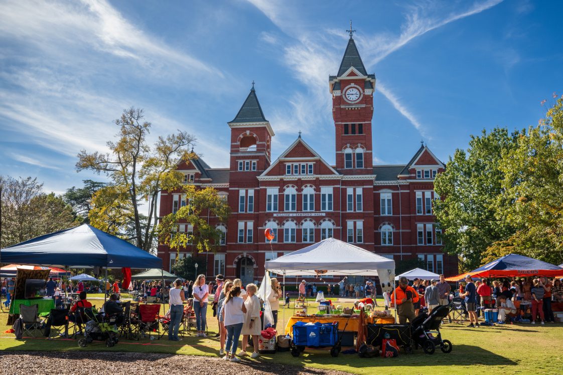 People tailgating outside Samford Hall on the campus of Auburn University.