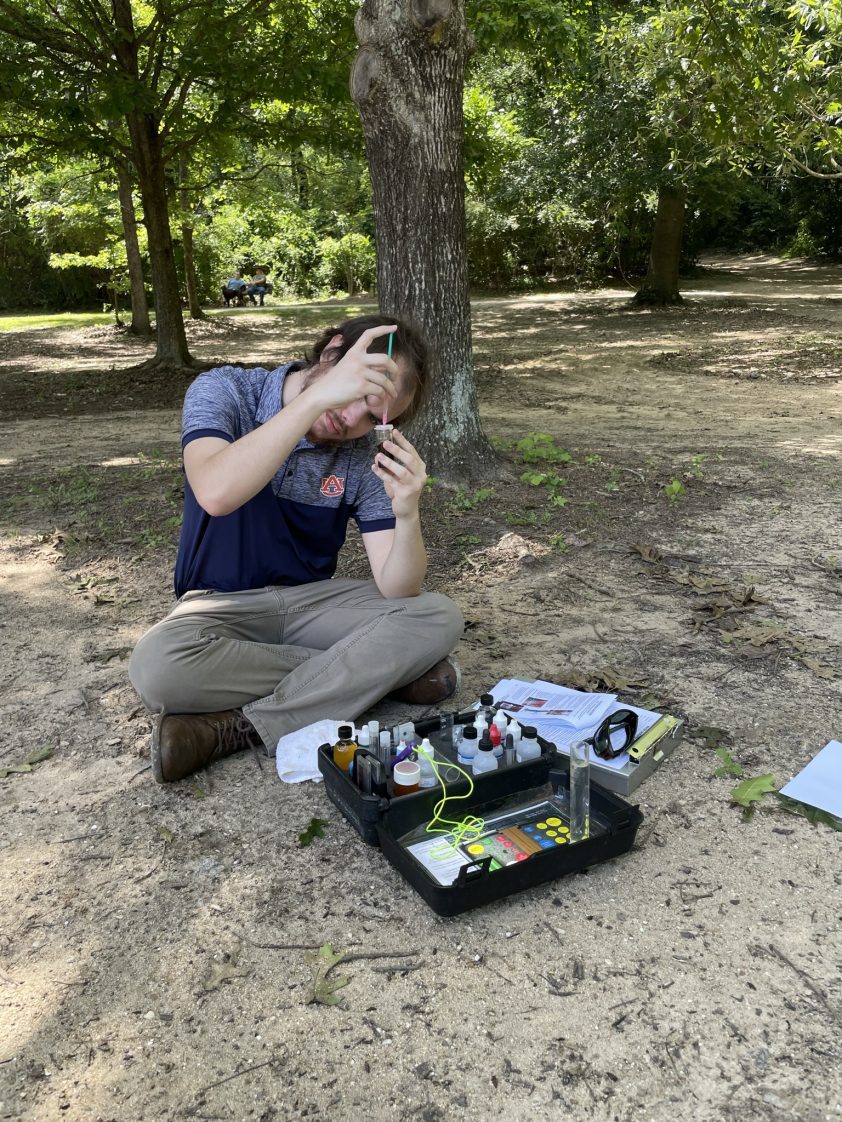 Patrick Smith collecting and analyzing water samples as an Alabama Extension Summer Internship Participant.