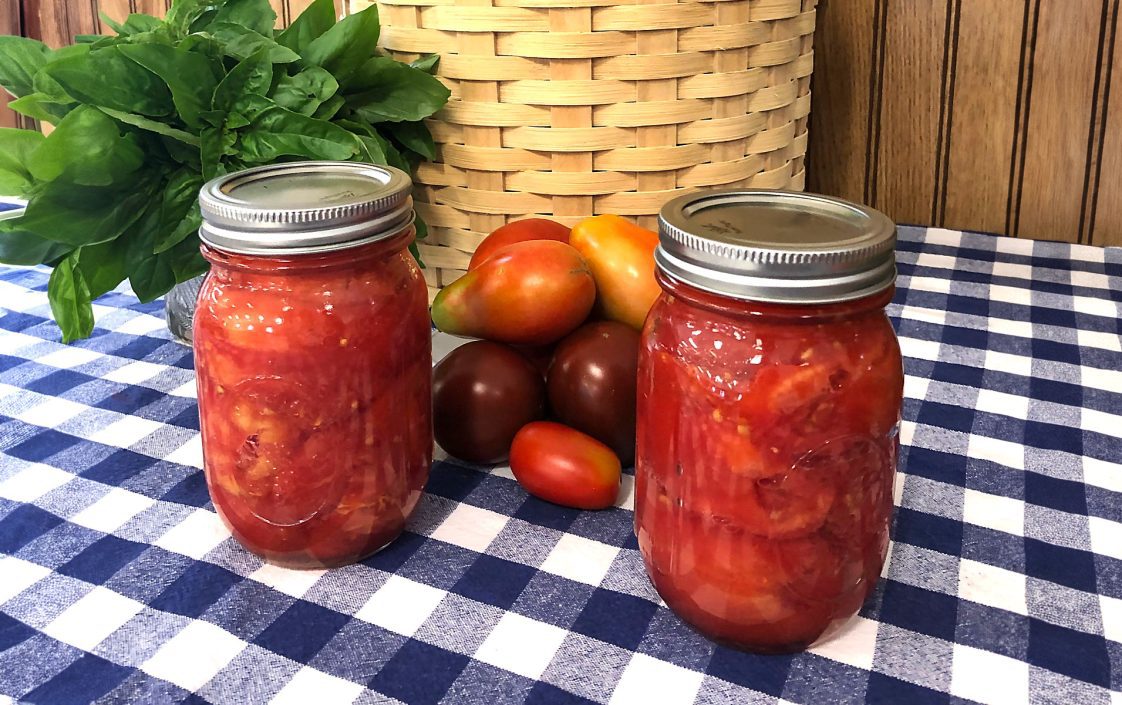 Jars of tomatoes preserved by water bath canning.