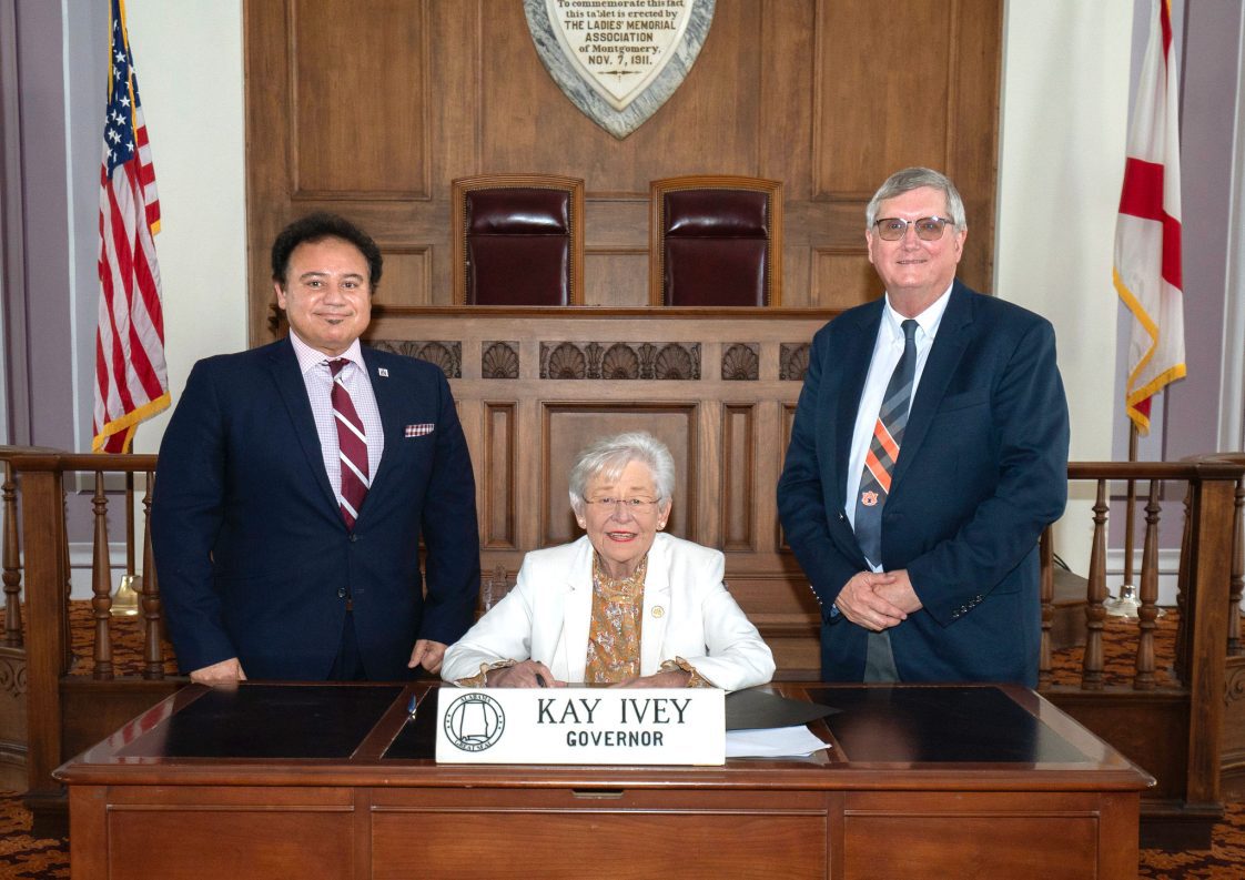 Majeed Dweik, Governor Kay Ivey, and Mike Phillips pose for a proclamation signing.