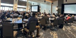 A crowd of people listening to a presentation at the 2024 drone conference.