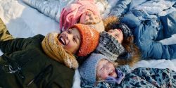 kids smiling in the snow