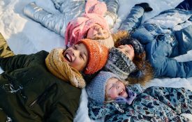 kids smiling in the snow